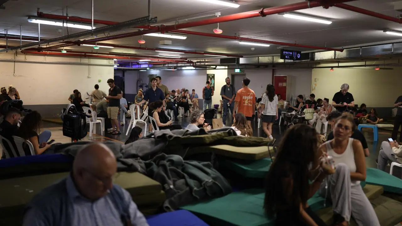People take cover in a public shelter during a rocket attack alert in Tel Aviv. PIC/AFP